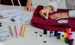 Attractive young woman fashion designer standing and working in studio