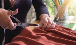 Young woman dressmaker or designer working as fashion designers measure and Cutting for clothes, profession and job occupation, Fashion Designer Stylish Concept.