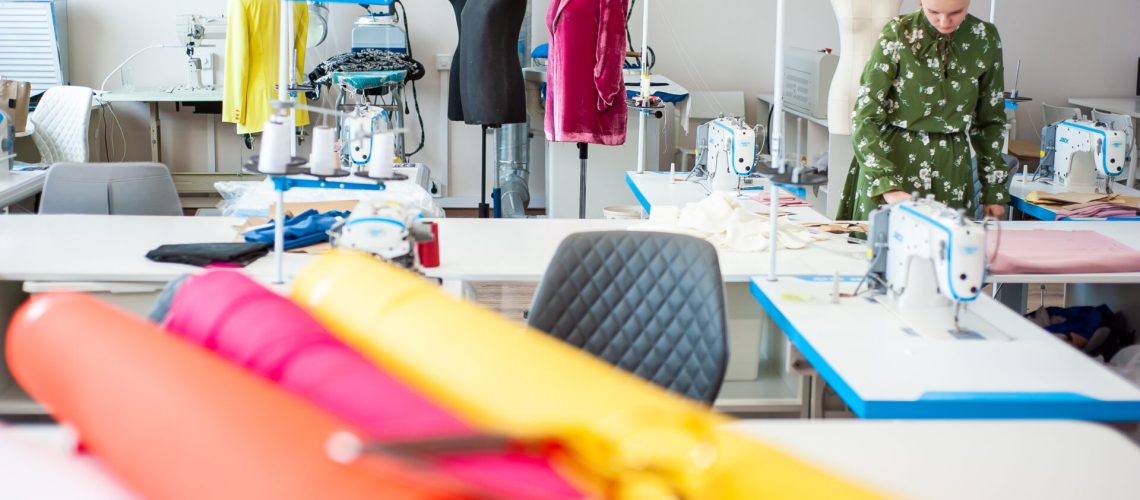 sewing-factory-concept-spools-thread-basic-sewing-tools-including-pins-needle